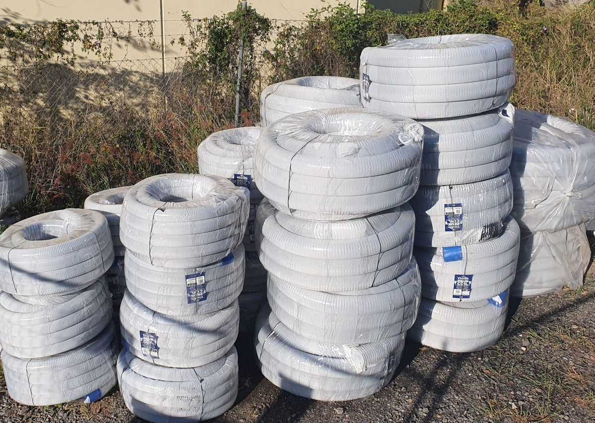 Socked agi pipe drainage coil used behind a concrete sleeper retaining wall